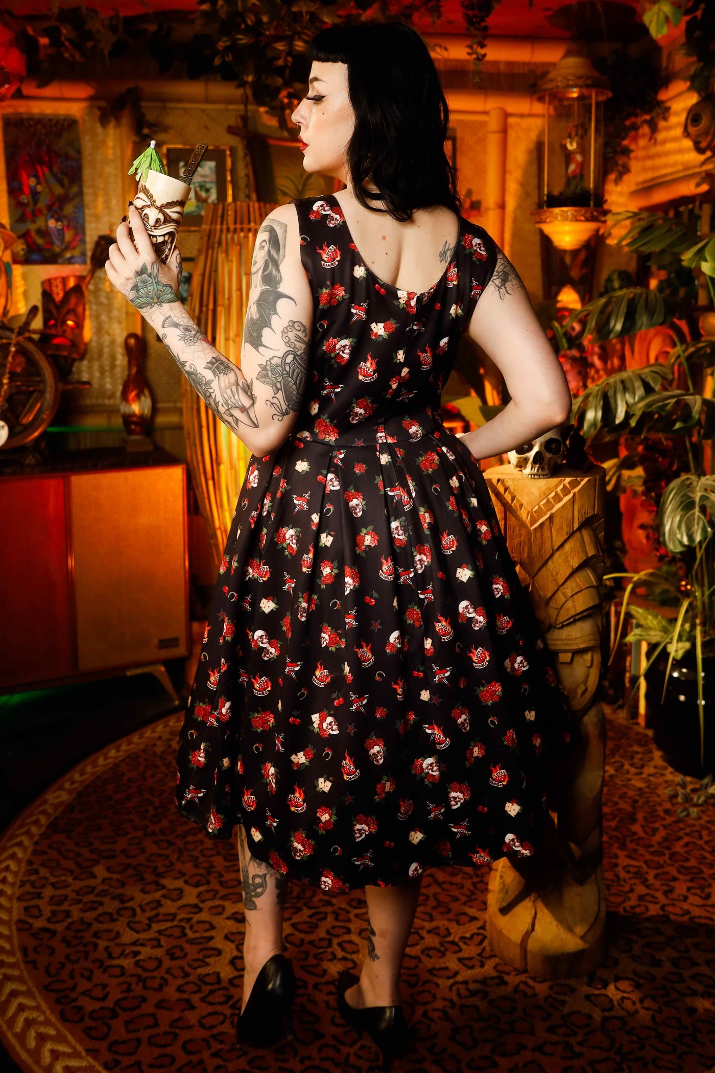 A lady wearing a Rockabilly Skull & Rose Swing Dress