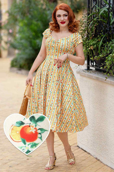 A model wearing a Sicilian Orange Stripe Swing Dress