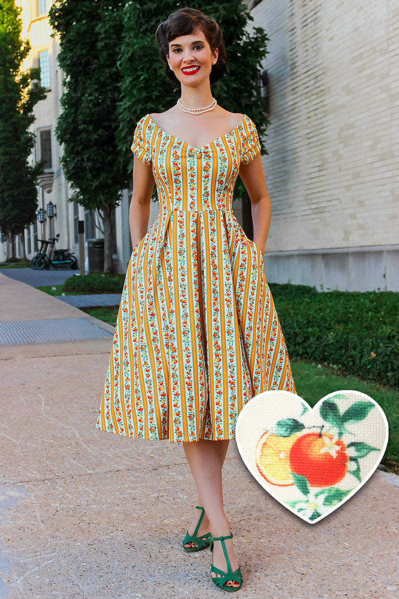 A model wearing a Sicilian Orange Stripe Swing Dress