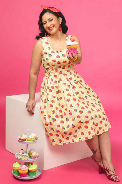 A model wearing a Strawberry Yellow Gingham Flared Dress