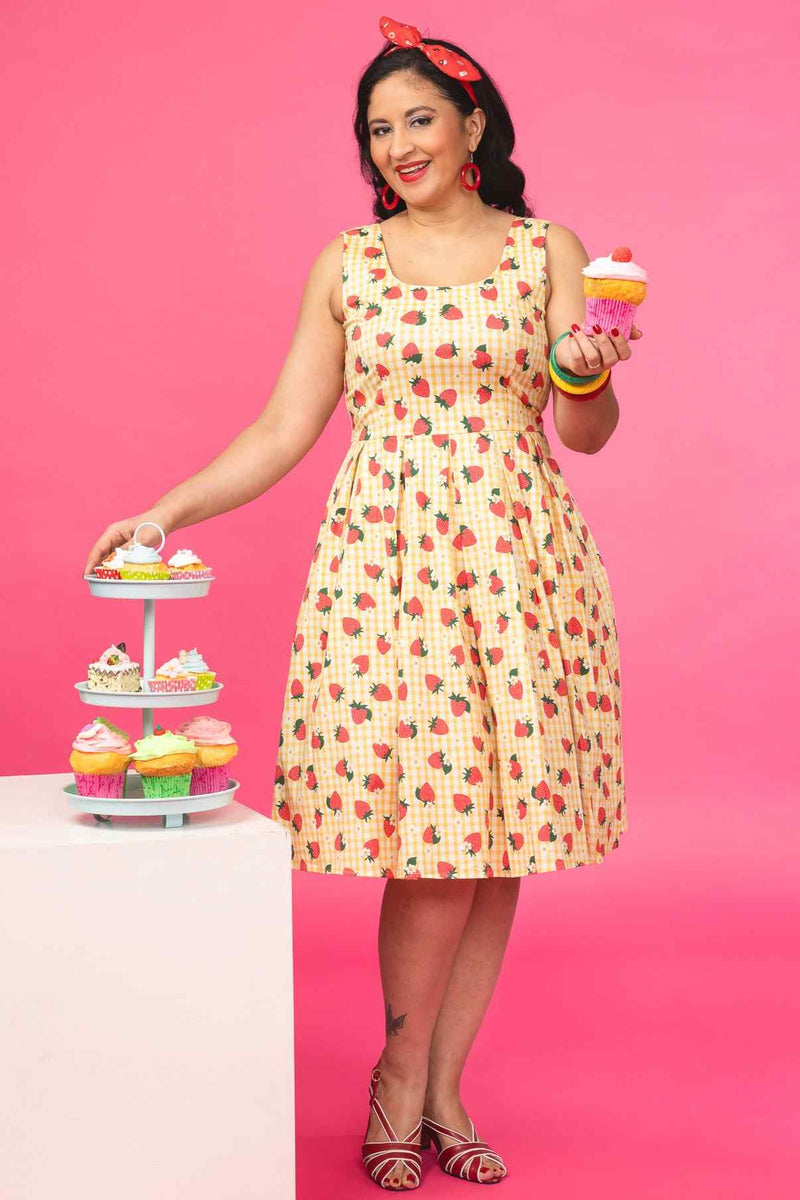 A model wearing a Strawberry Yellow Gingham Flared Dress