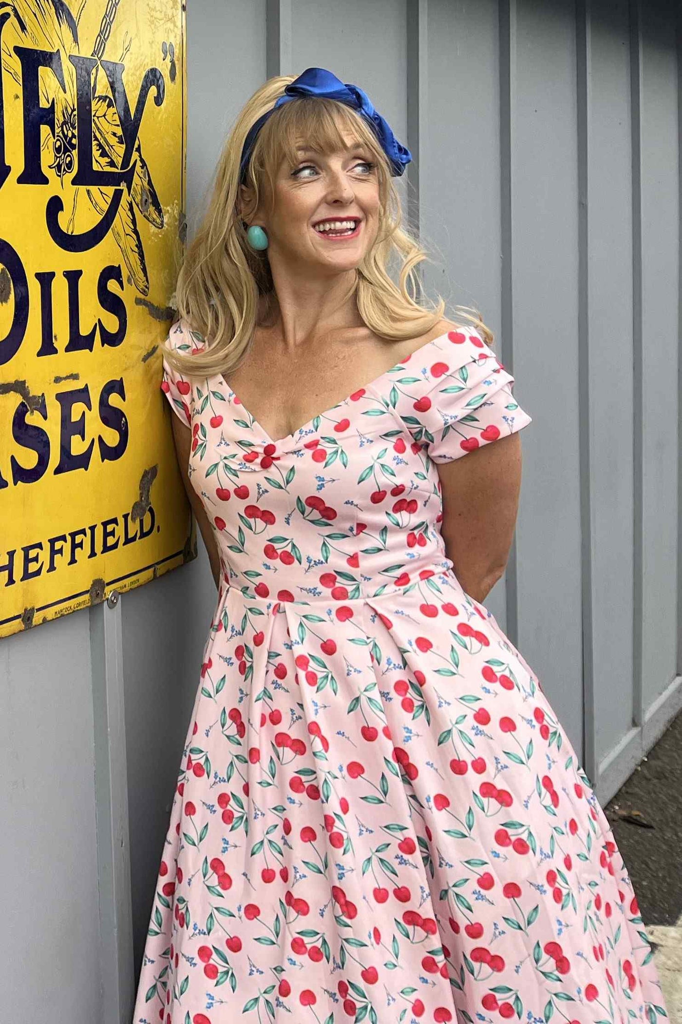 A lady wearing a Cherry Pink Off Shoulder Dress