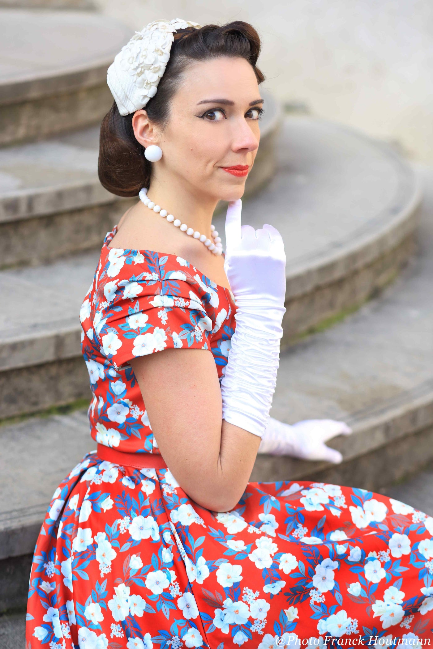 A lady wearing a White Rose Off Shoulder Dress In Red