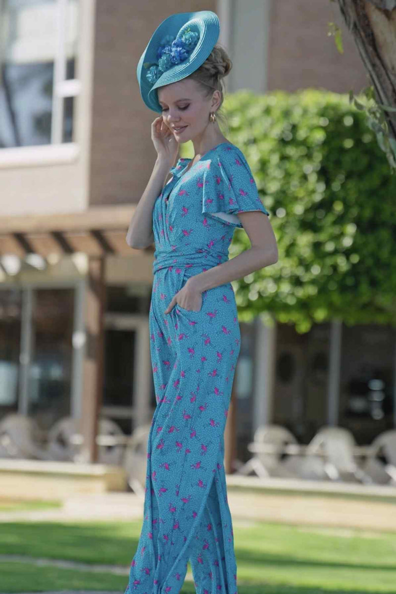 A lady wearing a Pink Flamingo & Pebble Turquoise Jumpsuit